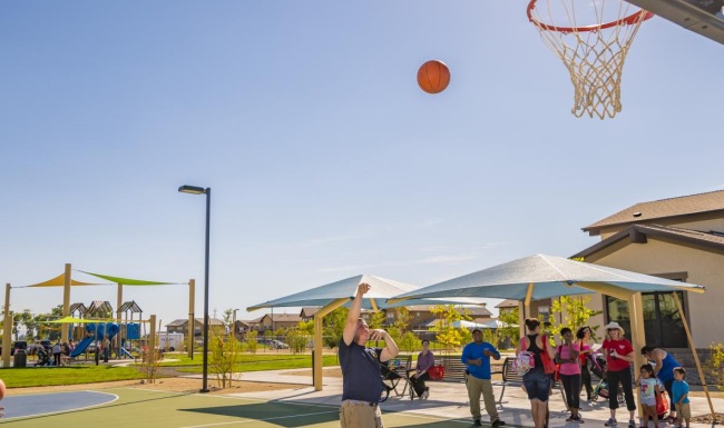 a group of people playing basketball