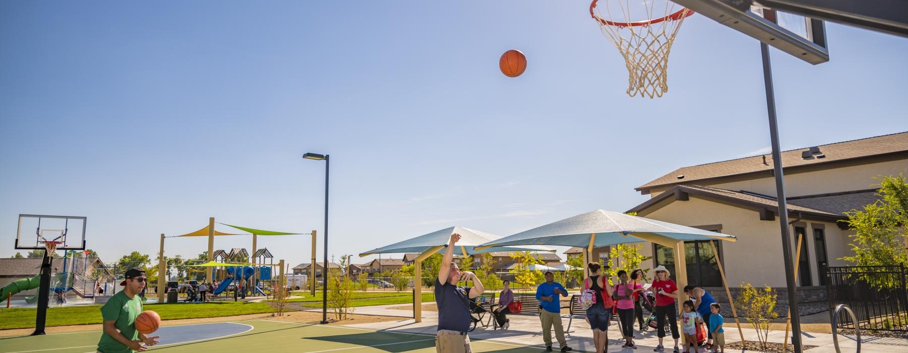 a group of people playing basketball