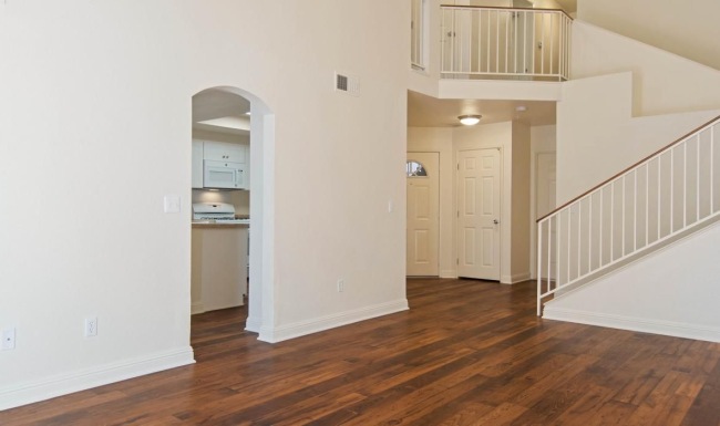 a room with white walls and wood floors