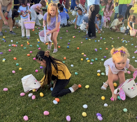 Kids picking up easter eggs on grass
