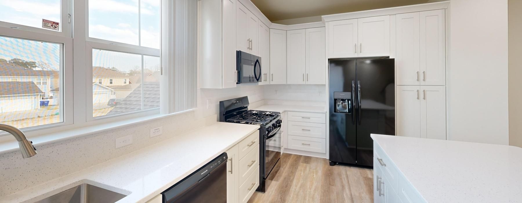 a kitchen with white cabinets
