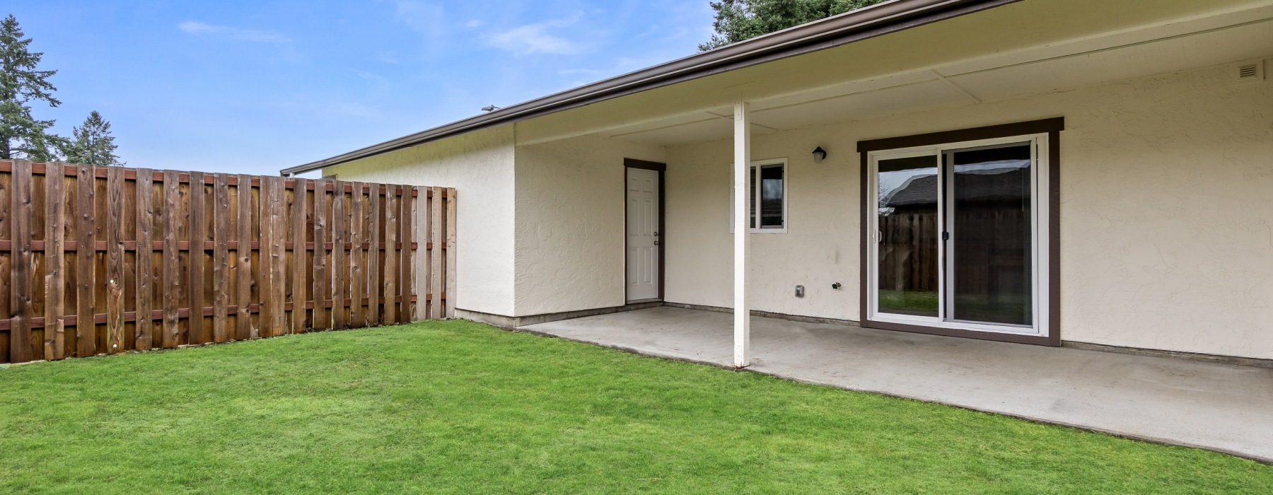 Covered Backyard with Fenced in Yard