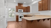 a kitchen with wood cabinets
