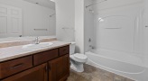 a bathroom with a shower, toilet and sink