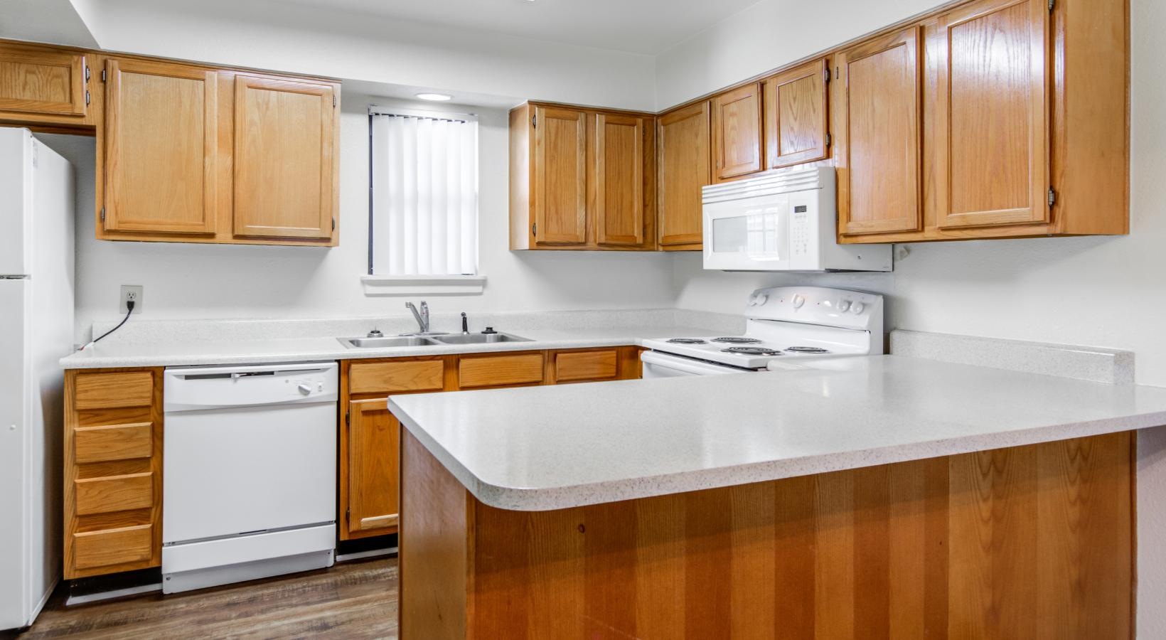 a kitchen with wooden cabinets