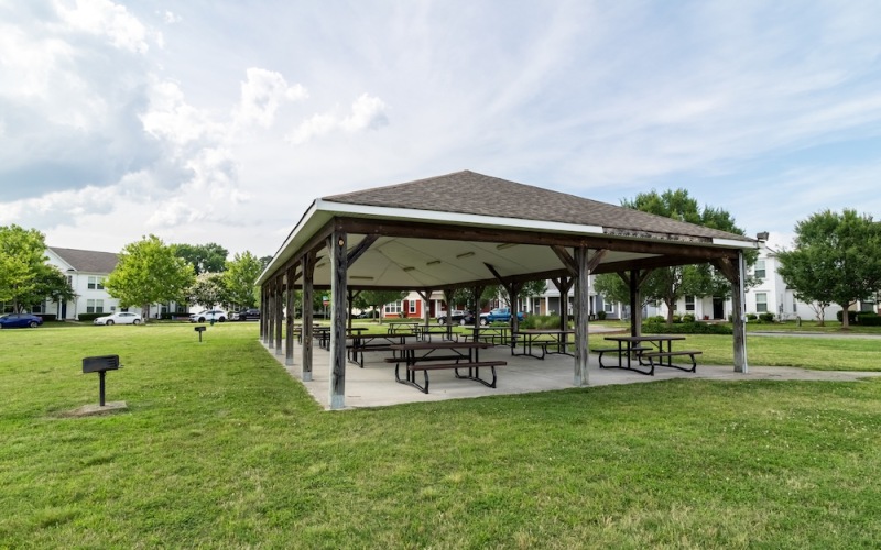 a pavilion on a green lawn