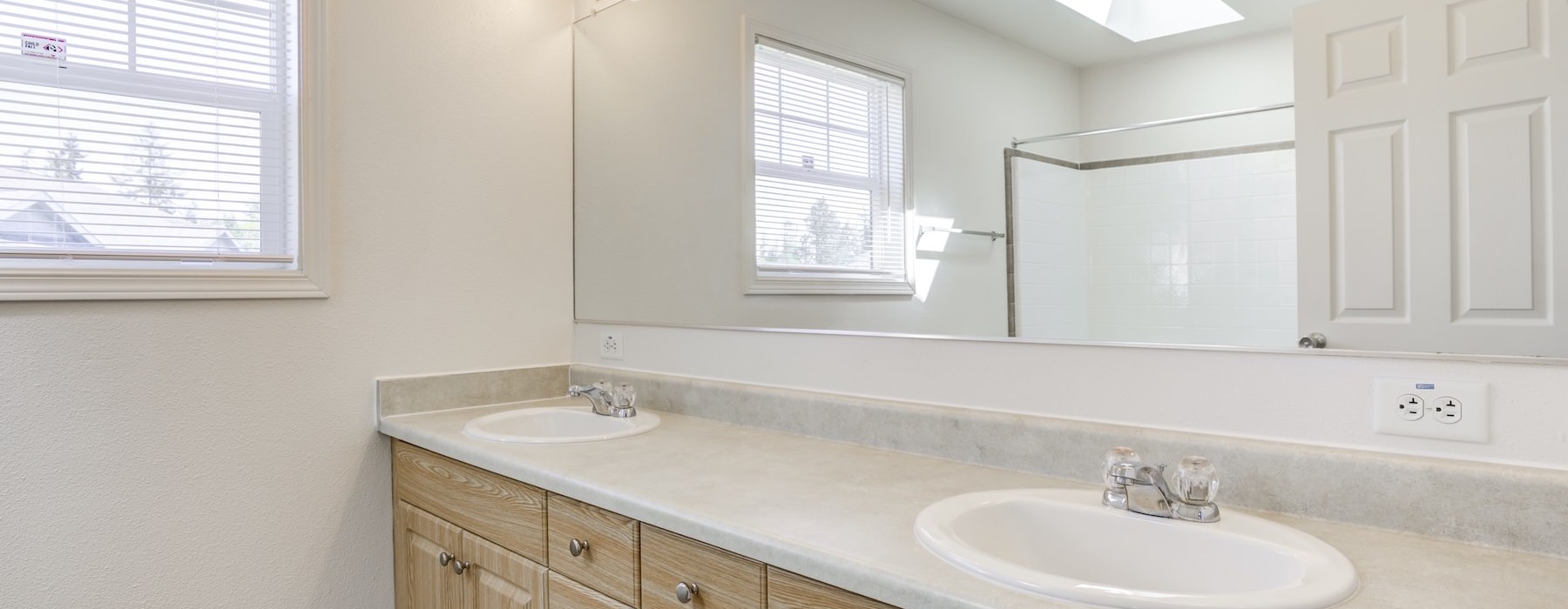 a bathroom with dual vanities