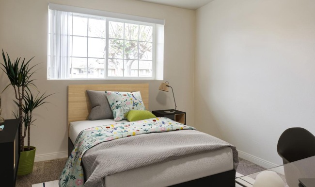 a bedroom with a fan and a bed