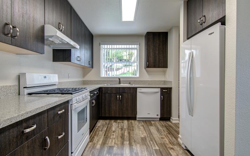 a kitchen with wooden cabinets