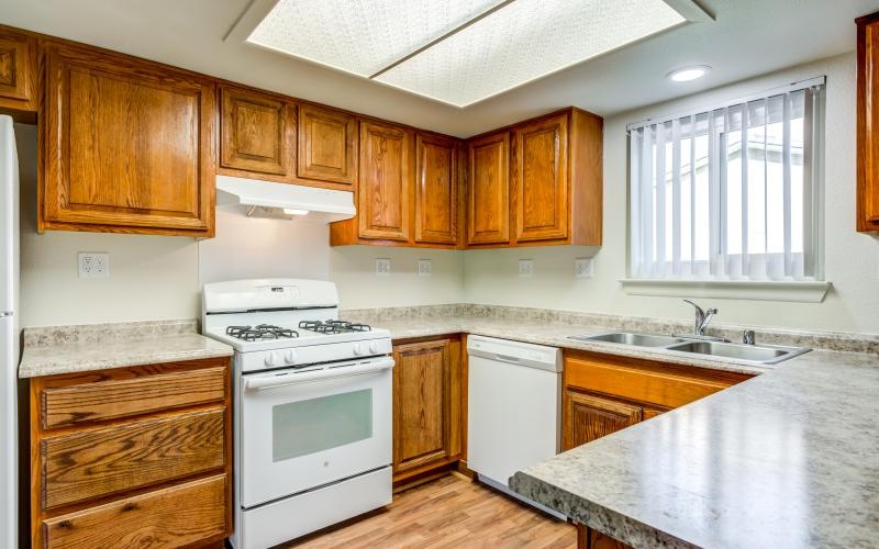 a kitchen with wooden cabinets