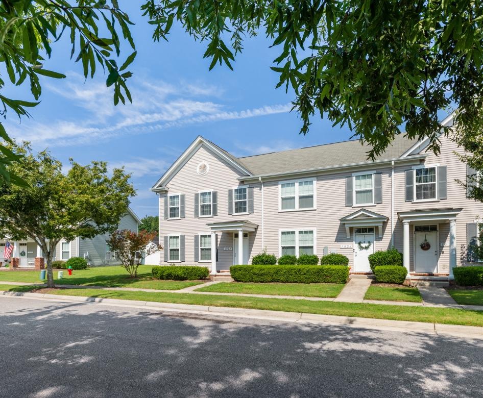 a large house with trees and grass