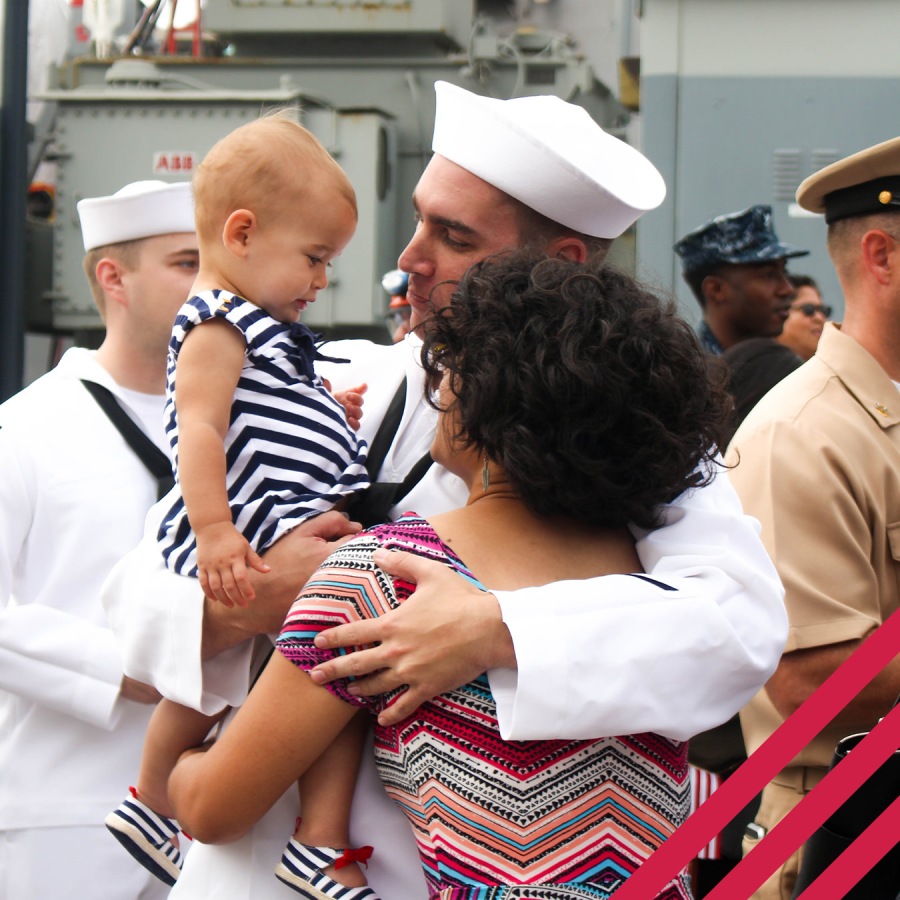 military family hugging with baby in arm
