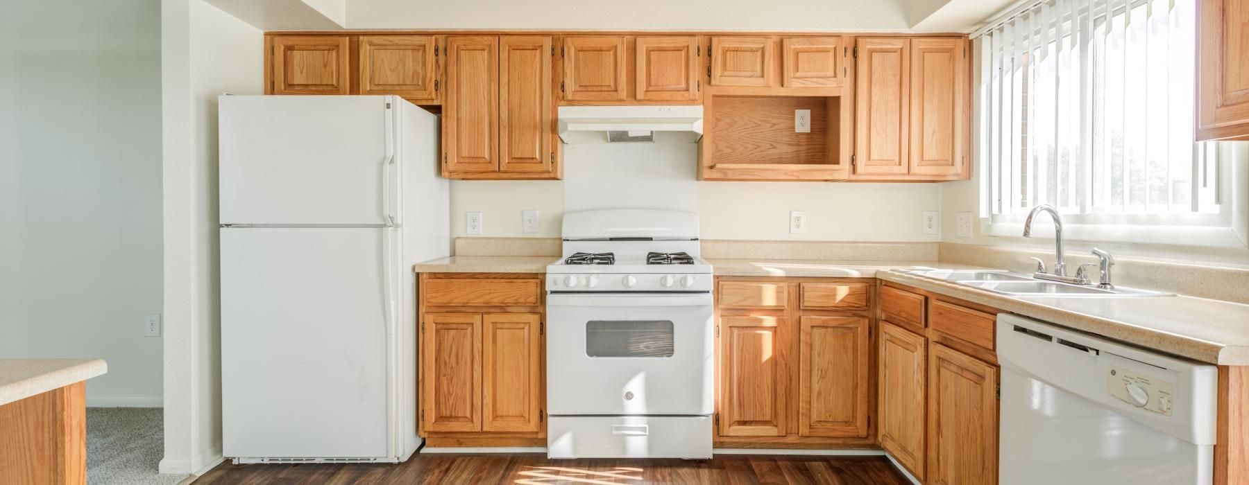 a kitchen with wooden cabinets