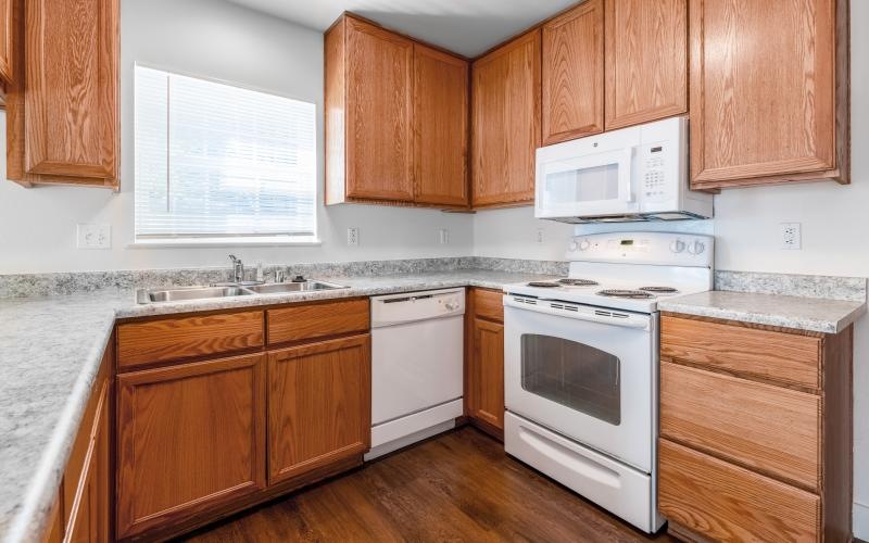 a kitchen with wooden cabinets