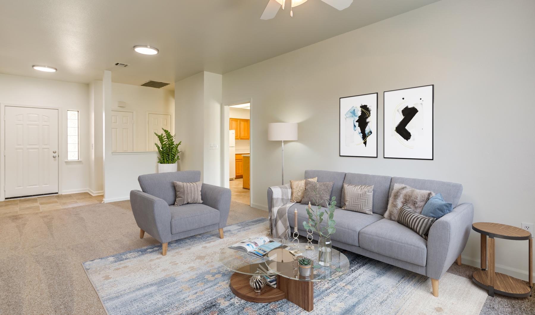 a living room with a couch and a fan