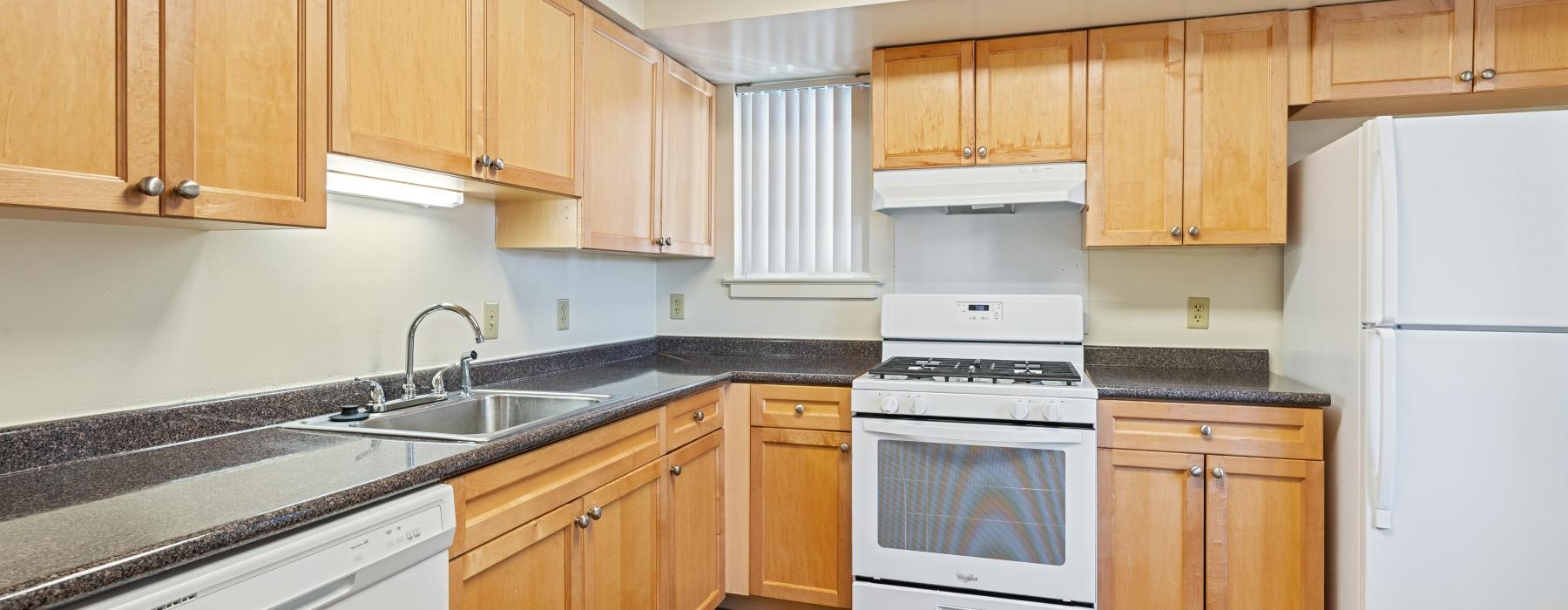 a kitchen with wooden cabinets