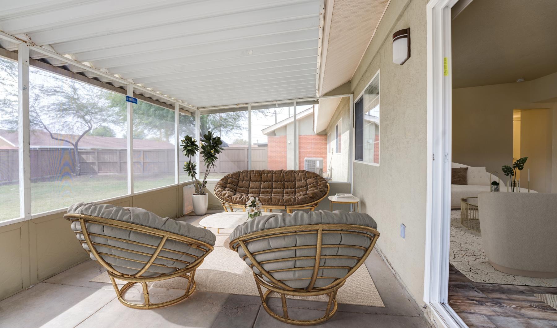 covered patio with seating and plants