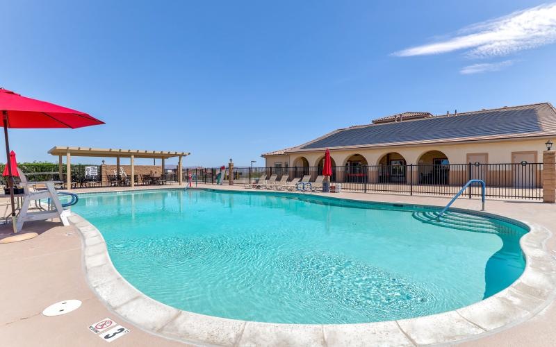 a swimming pool with a building in the background