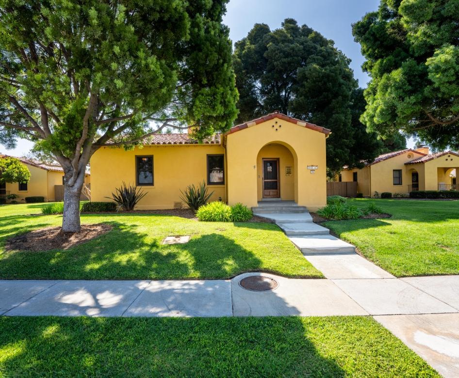 a yellow house with a driveway