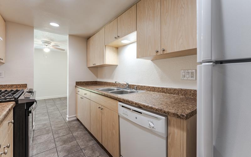 a kitchen with wooden cabinets