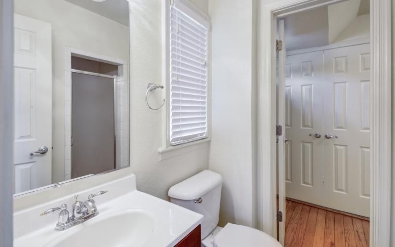 a bathroom with a sink toilet and mirror