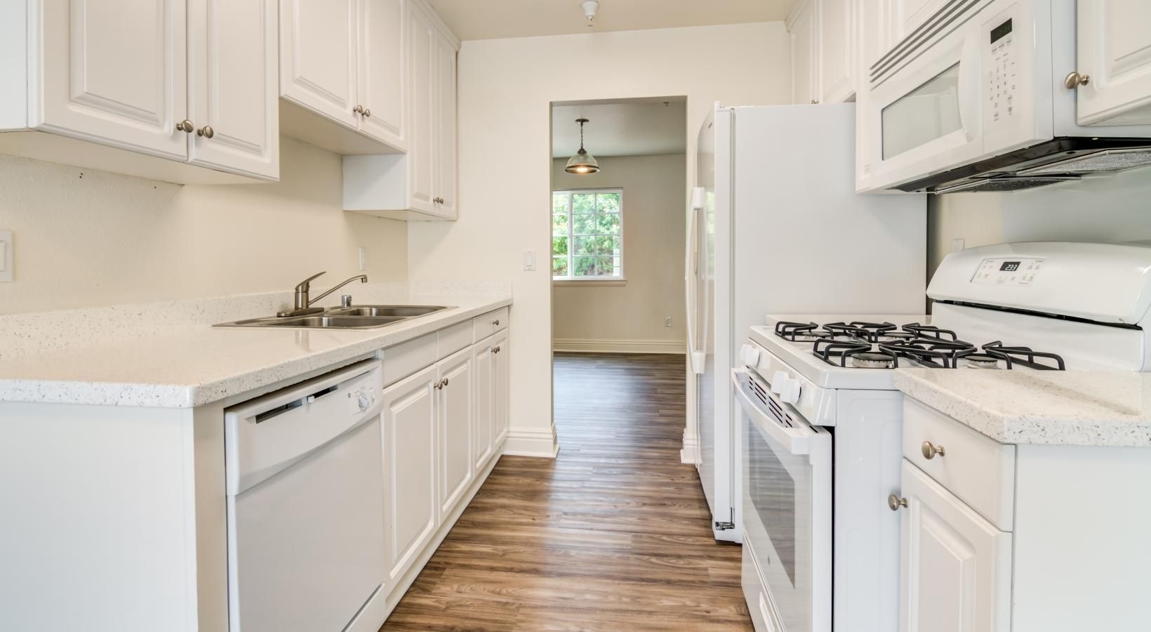 a kitchen with white cabinets