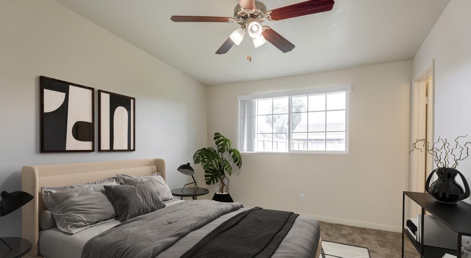 a bedroom with a bed and a fan