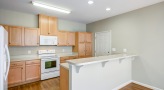 a kitchen with wooden cabinets and white appliances
