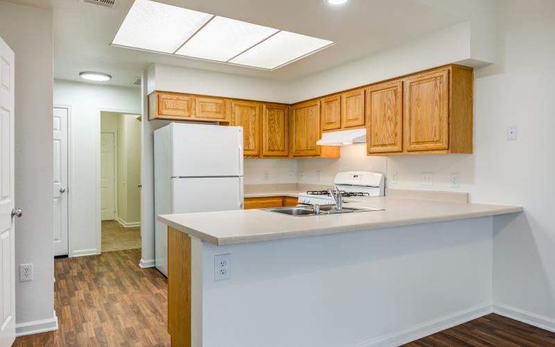 a kitchen with wooden cabinets