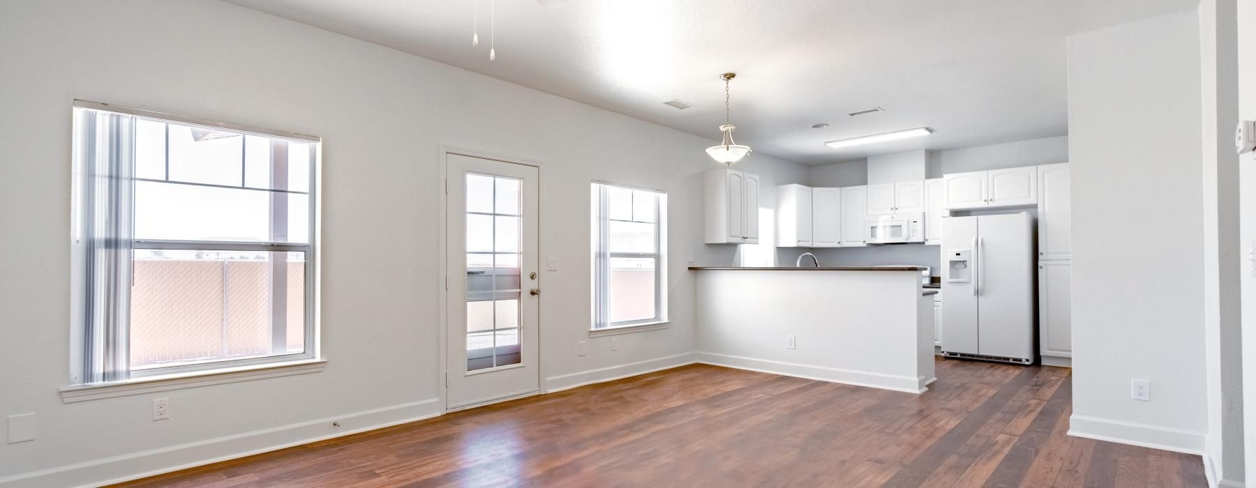 a large kitchen and living space with a wood floor