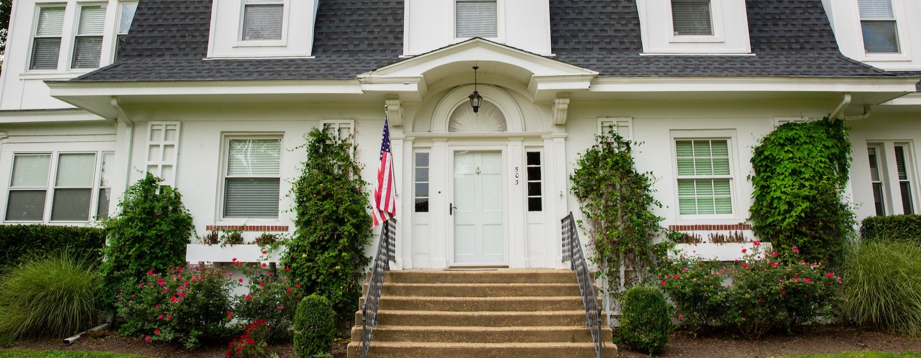 a large white house with an American flag