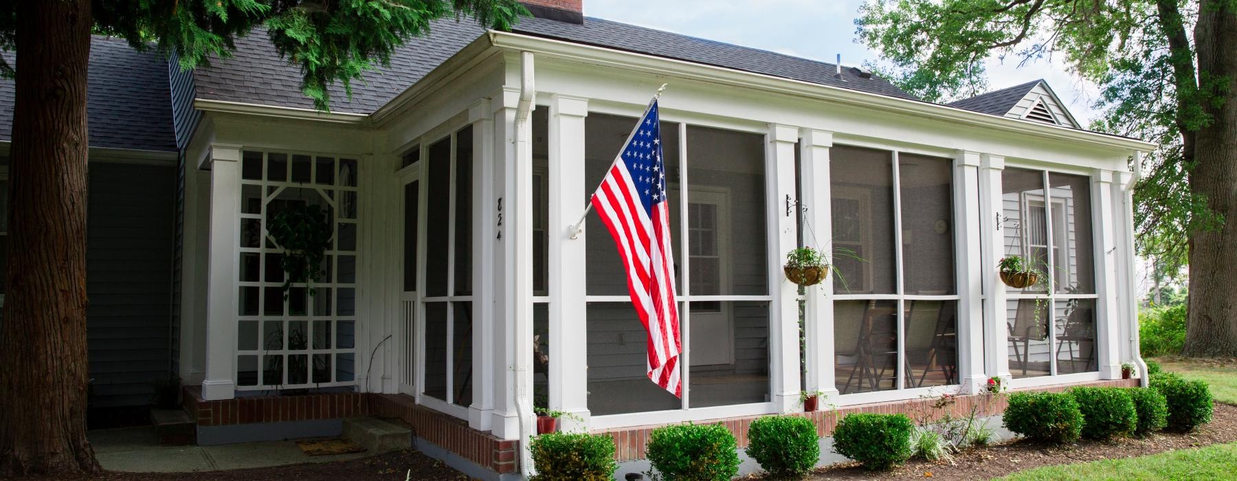a house with a flag on the porch