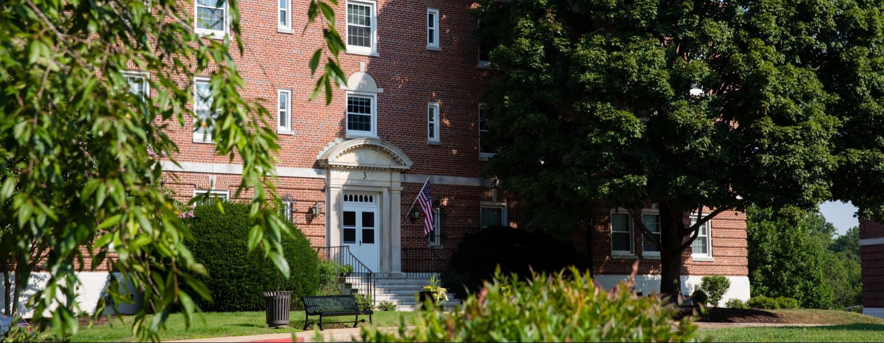 a brick building with trees in front of it
