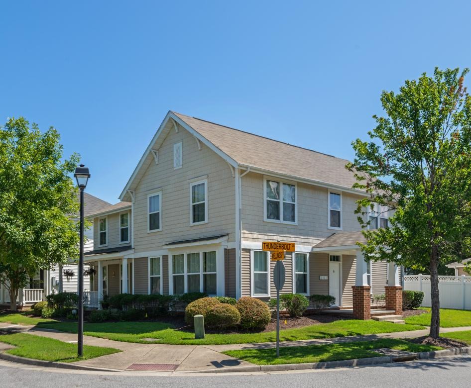 a large house with trees on street corner