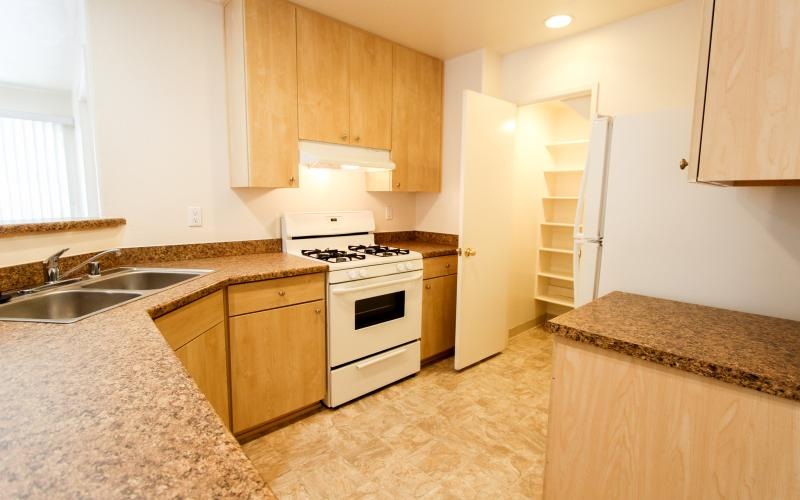 a kitchen with wooden cabinets