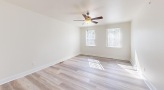 a room with a wood floor and a ceiling fan
