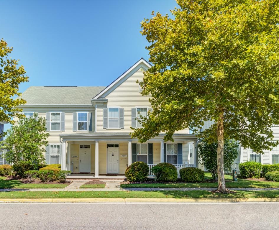 a large house with trees in front