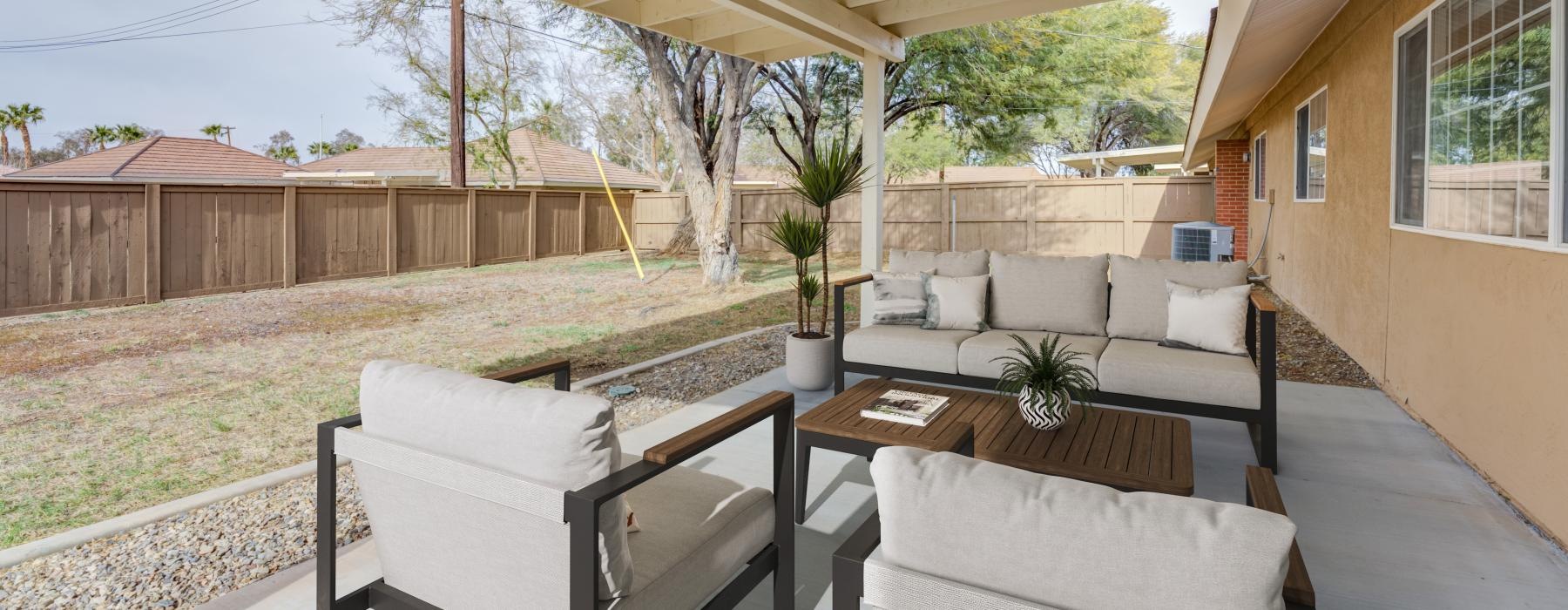 a patio with a table and chairs
