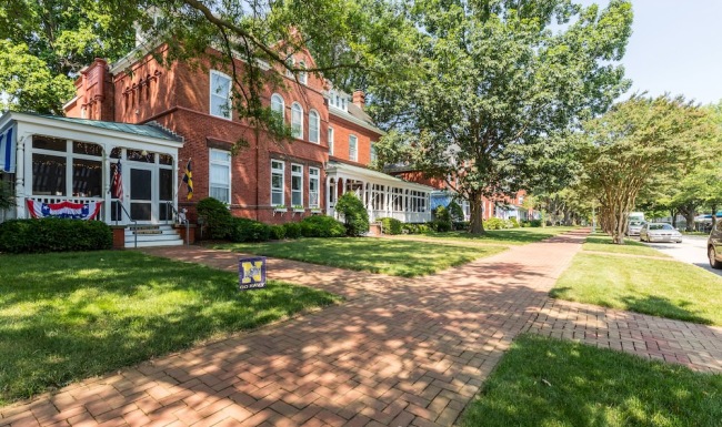 a house with trees and bushes in front of it