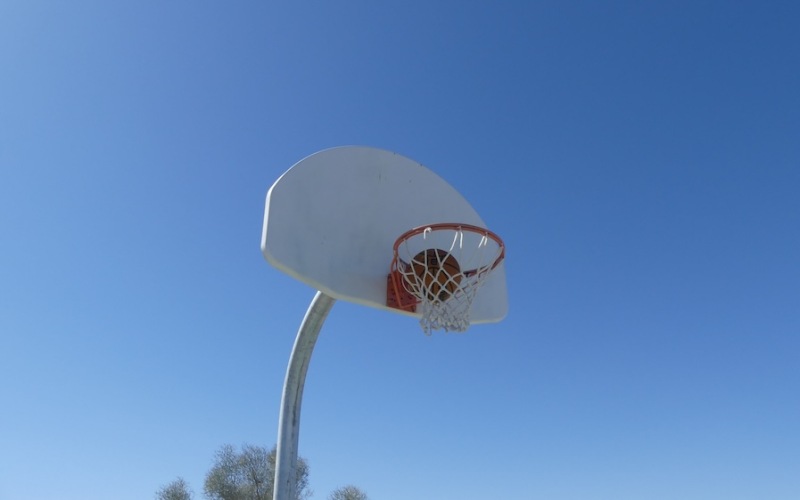 a basketball goal under a blue sky