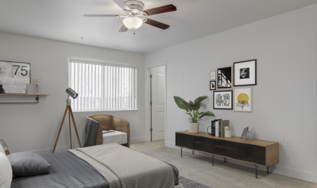a bedroom with a bed and a fan