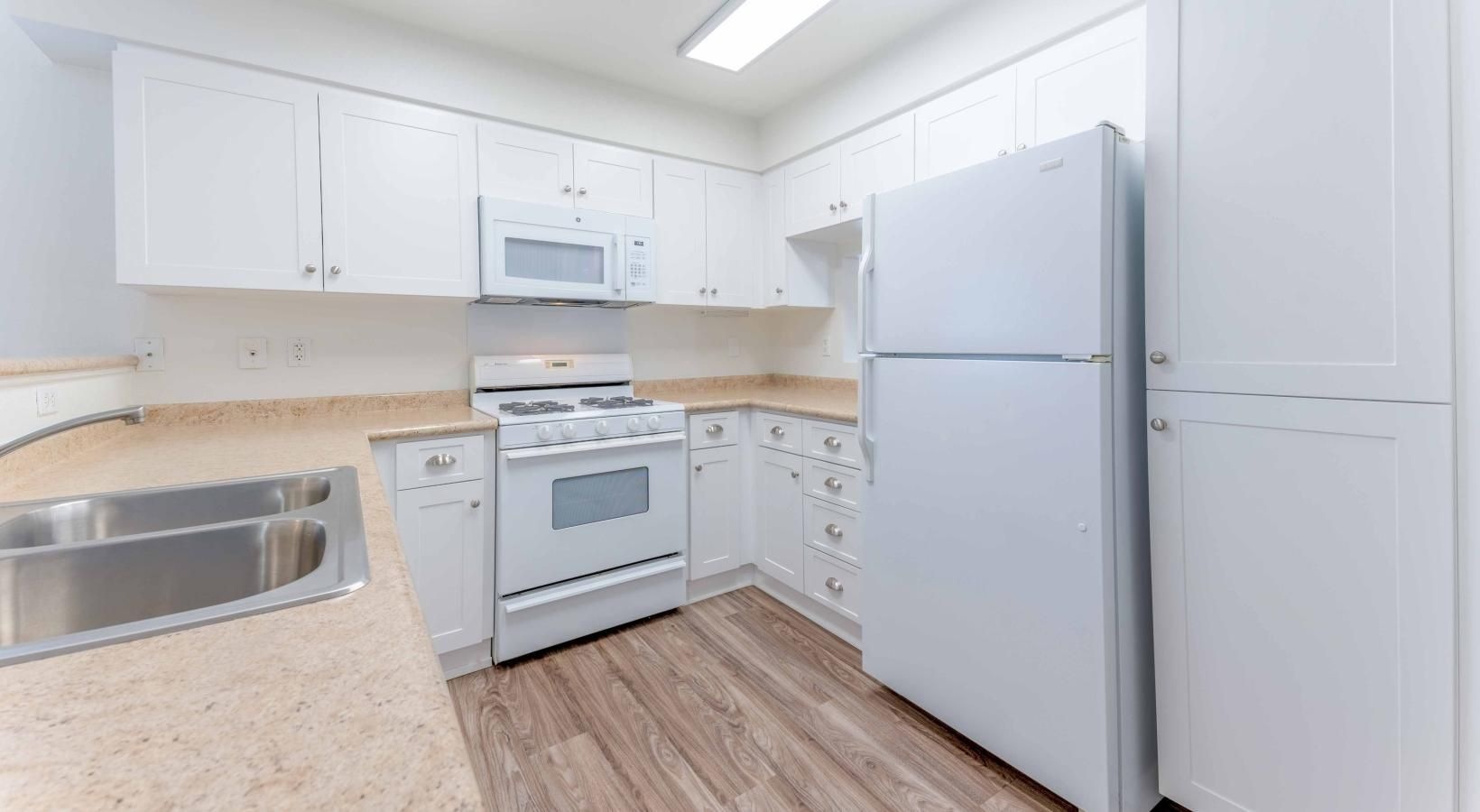 a kitchen with white cabinets