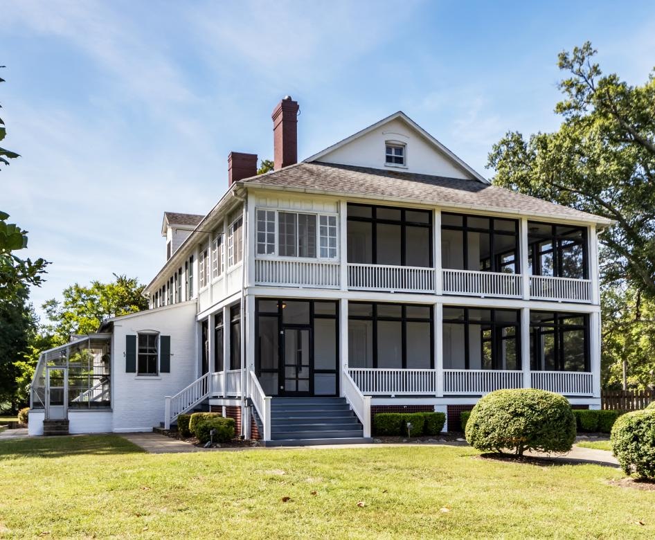 a large house with a lawn in front of it with Harding Home in the background