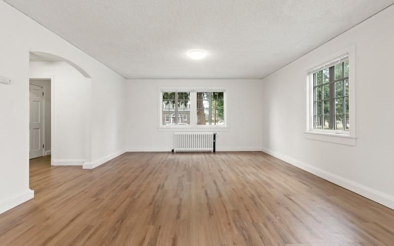 a room with a wood floor and a window