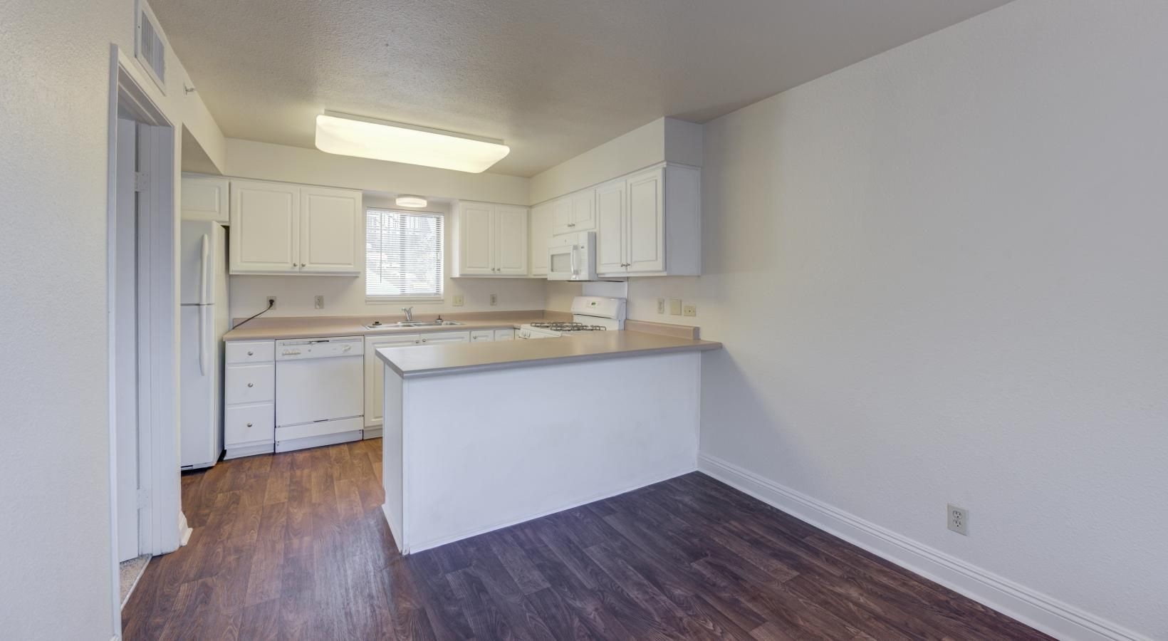 a kitchen with white cabinets