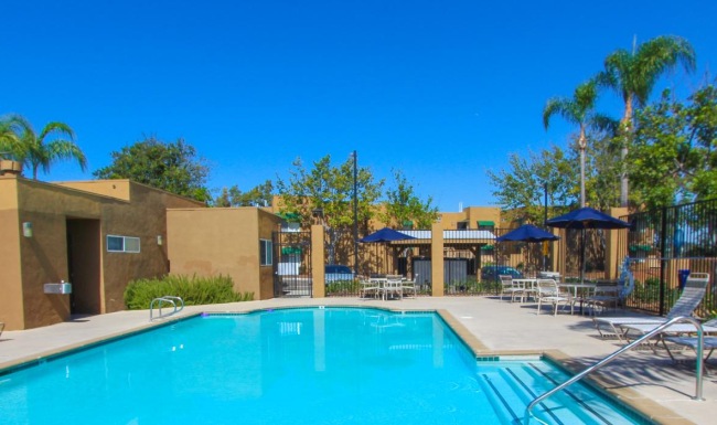 a swimming pool with chairs around it