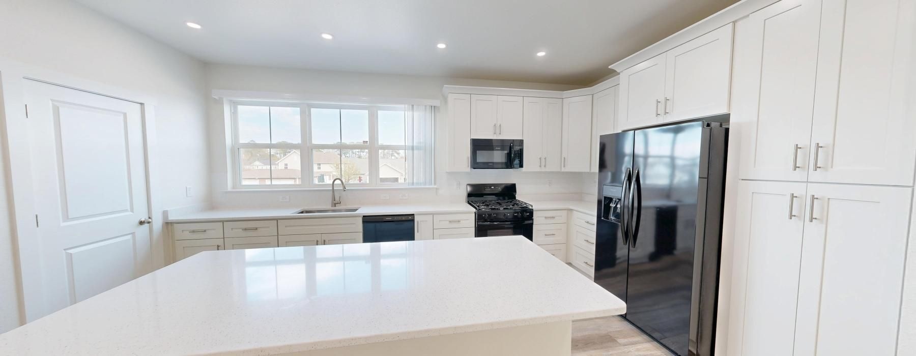 a kitchen with white cabinets