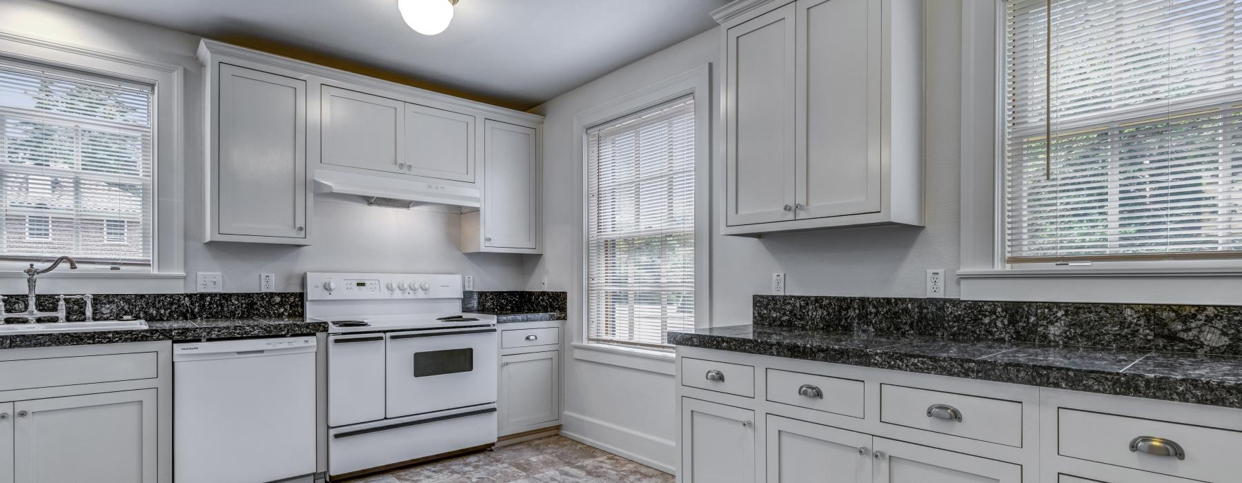 a kitchen with white cabinets