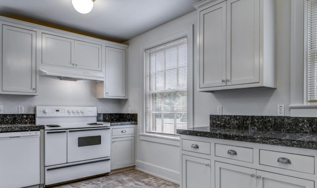 a kitchen with white cabinets