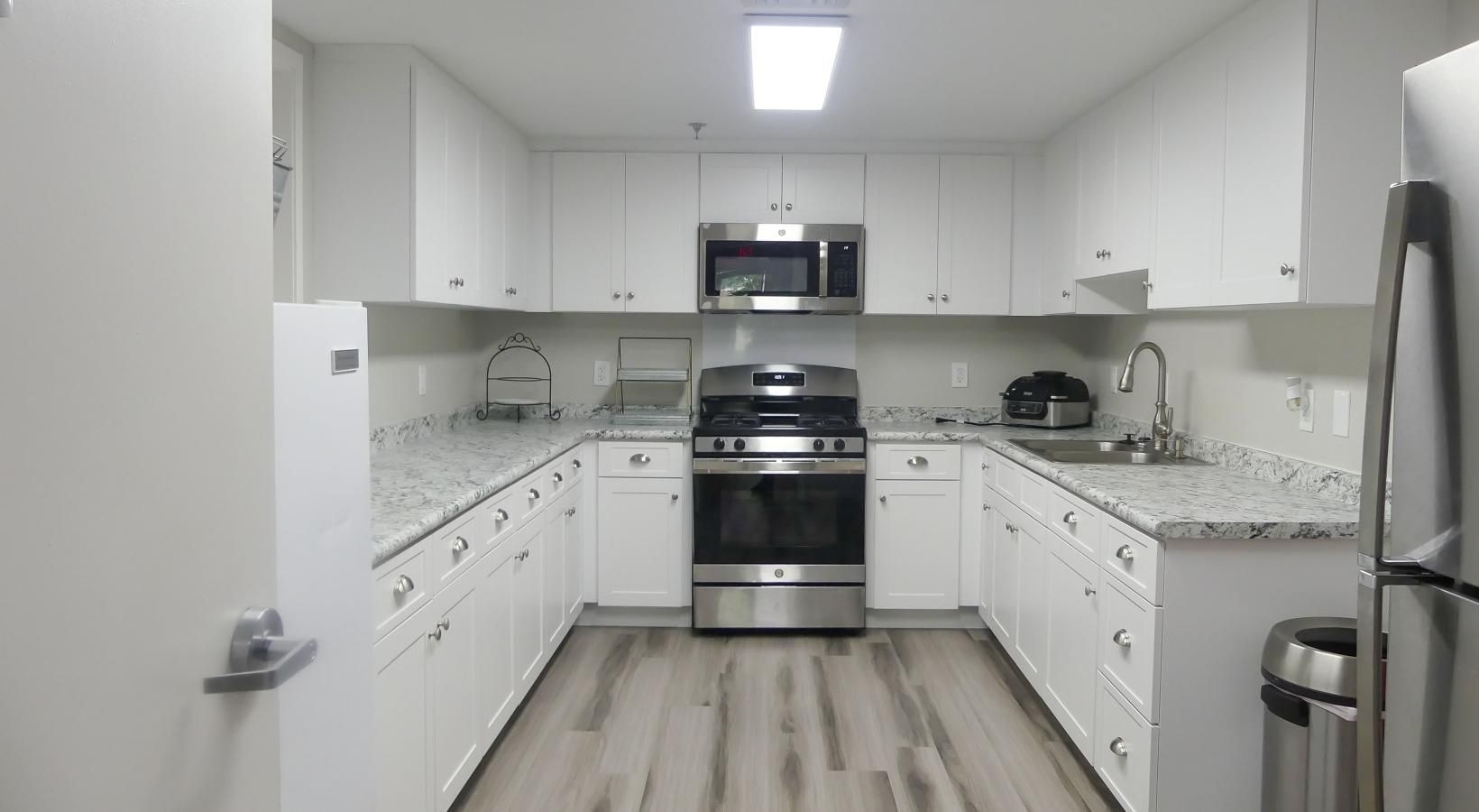 a kitchen with white cabinets